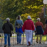 women walking with aids 