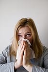 woman covering nose
